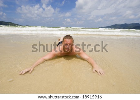 The man sunbathes on a beach