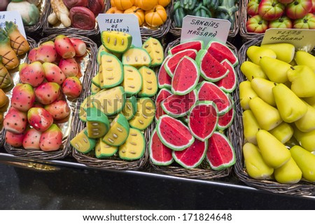 An assortment of fruit shaped marzipan in baskets at a market