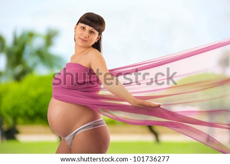 Portrait of a young pregnant woman wrapped in cloth