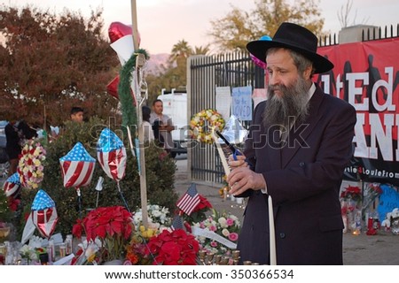 SAN BERNARDINO, CA - DECEMBER 6: Jewish rabbi lights first Hanukkah candle at a makeshift memorial to IRC shooting victims on December 6, 2015 in San Bernardino, California.