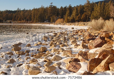 Rocks on the shore of a frozen lake; Big Bear Lake, California