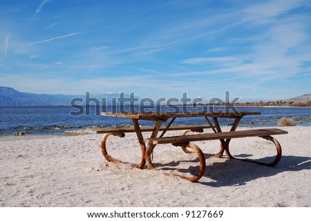 Old picnic table on beach along lake; Salton Sea; Bombay Beach, California