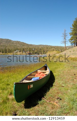 Canoe on lake shore; Big Bear Lake, California