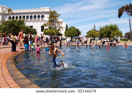 SAN DIEGO, CA - APRIL 19: Visitors cooling off in a fountain pool at Earth Fair on April 19, 2009 in San Diego. The fair is a large annual event held at Balboa Park in San Diego.