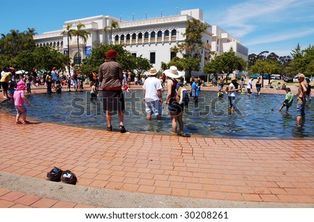 SAN DIEGO, CA - APRIL 19: Visitors cool off in a fountain pool at Earth Fair on April 19, 2009 in San Diego. The fair is a large annual event held at Balboa Park.