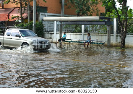BANGKOK - NOVEMBER 7: Car navigating through the flood after the heaviest monsoon rain in 20 years in the capital  on November 7, 2011  Nuan Chan Road, bangkok, Thailand.