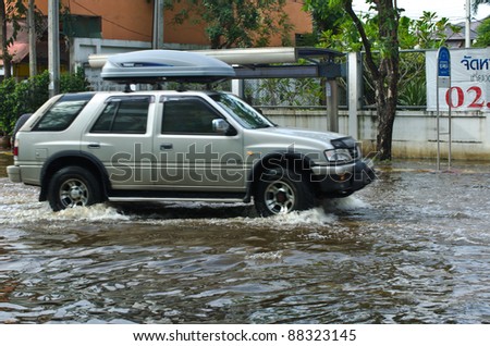 BANGKOK - NOVEMBER 7: Car navigating through the flood after the heaviest monsoon rain in 20 years in the capital  on November 7, 2011  Nuan Chan Road, bangkok, Thailand.