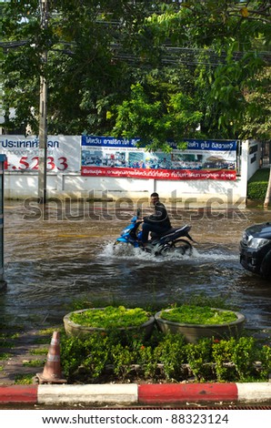 BANGKOK - NOVEMBER 7: Motorcycle navigating through the flood after the heaviest monsoon rain in 20 years in the capital  on November 7, 2011  Nuan Chan Road, bangkok, Thailand.