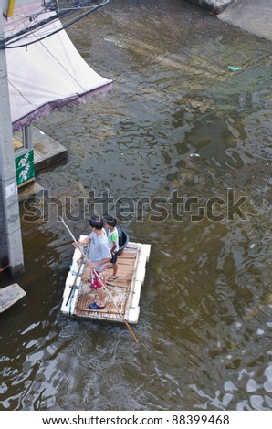 BANGKOK, THAILAND-NOVEMBER 8: People use boats and rafts as a transportation through water during the worst flooding in decades on November 8, 2011 Ngam Wong Wan Road, Bangkok, Thailand.