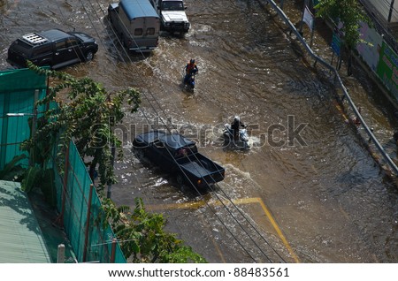 BANGKOK, THAILAND-NOVEMBER 9: Cars navigating through the flood after the heaviest monsoon rain in 20 years in the capital  on November 9, 2011  Nuan Chan Road, bangkok, Thailand.