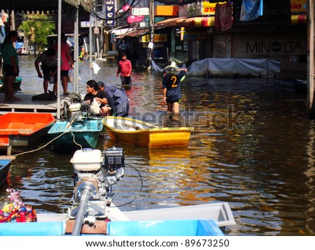 BANGKOK, THAILAND-NOVEMBER 27: People are using boats as a transportation through water during the worst flooding in decades on November 27, 2011, Ram Inthra 39, Ram Inthra Road, bangkok, Thailand.