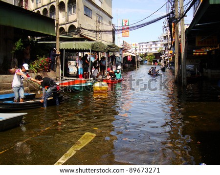 BANGKOK, THAILAND-NOVEMBER 27: People are using boats as a transportation through water during the worst flooding in decades on November 27, 2011, Ram Inthra 39, Ram Inthra Road, bangkok, Thailand.
