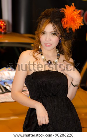 BANGKOK, THAILAND - DECEMBER 6: Unidentified female presenter at Solax booth in THE 28th THAILAND INTERNATIONAL MOTOR EXPO 2011 on December 6, 2011 in Bangkok, Thailand.