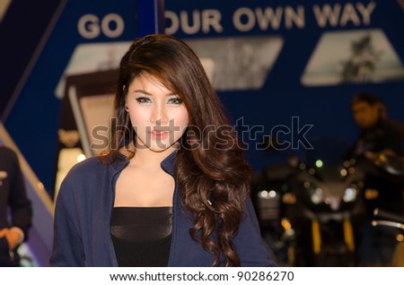 BANGKOK, THAILAND - DECEMBER 6: Unidentified female presenter at Triumph booth in THE 28th THAILAND INTERNATIONAL MOTOR EXPO 2011 on DeCember 6, 2011 in Bangkok, Thailand.
