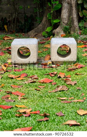 Two stone chair on  grass in a park