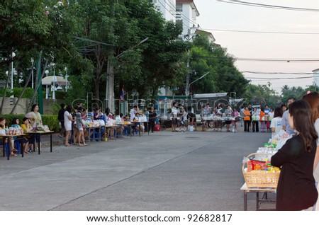 BANGKOK, THAILAND - JANUARY 8:Unidentified Bangkok people give food offerings for monks in new year day festival on Jan 8, 2012 at Baan Suan Thon village,Bangkok , Thailand