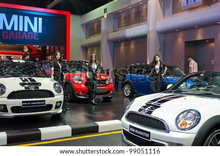 BANGKOK - MARCH 31: Mini cooper car with unidentified model on display at The 33th Bangkok International Motor Show on March 31, 2012 in Bangkok, Thailand.