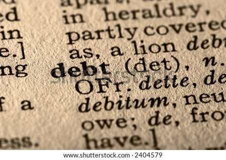 The word debt. Close-up of the word debt in a dictionary.