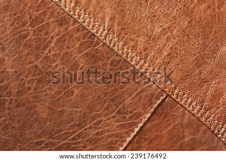 Brown leather texture, with stitching going across and diagonal.