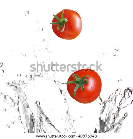 Tomatoes splashing in water