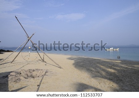 Dream catcher and boat on sand beach in Kapas island in Malaysia