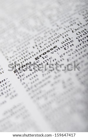 Close up of French dictionary page at word Fat and blur text