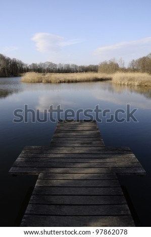 Lake of Saint Felix in Savoy and wooden pontoon forming a cross