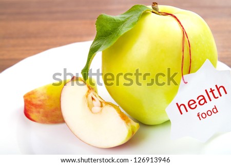 dieting and health food. Yellow, green apple with leaf and white sticker