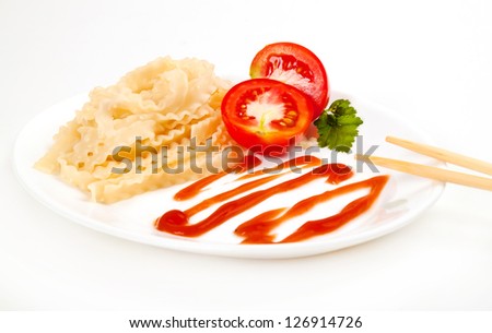 spaghetti, pasta, macaroni on plate with tomato, green leaf and chinese sticks