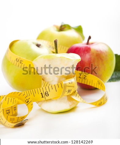 apple core and measuring tape. Diet concept