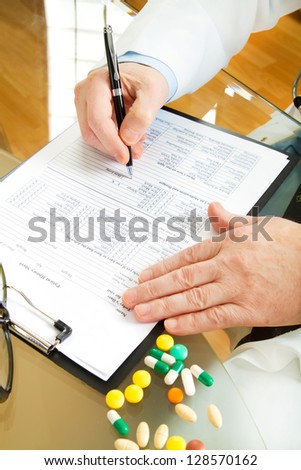 Doctor writing prescription selective focus
