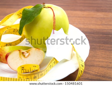 dieting and health food. Yellow, green apple with leaf, tape and sticker