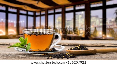 Glass Cup Tea with Mint Leaf, in evening cafe