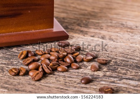 coffee beans and old coffee mill in shop, cafe on wooden table