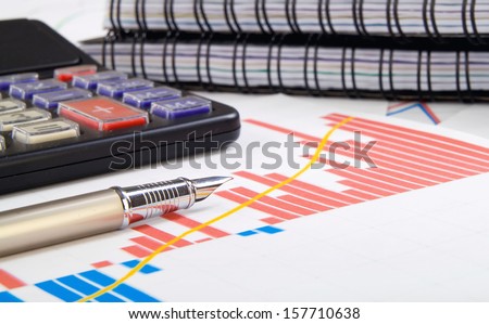 student, business workplace with pen calculator and charts