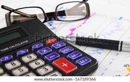 student, business workplace with calculator, pen, glasses and diagrams