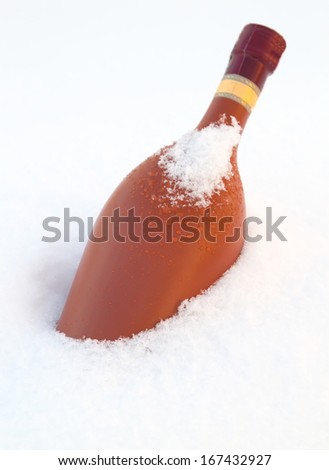 bottle of wine chilling in snow bank