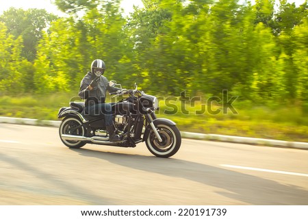 slow motion, biker riding unknown motorbike with blur movement, speed concept