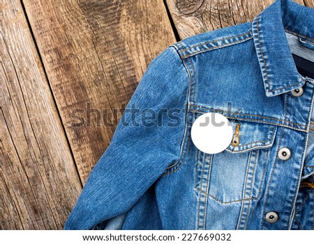 White round badge button on denim jacket