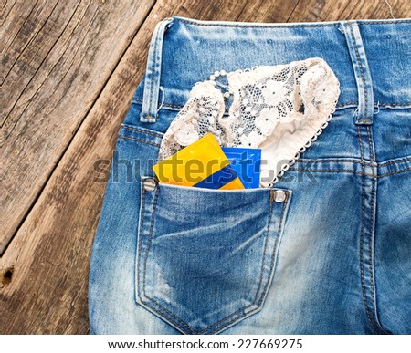 A young man in jeans with a woman\'s panties and condoms in his pocket