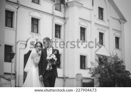 Wedding couple near old building black&white