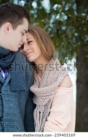 Happy Young woman hang up boyfriend in Winter Park