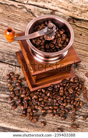 coffee beans and old coffee mill in shop, cafe on wooden table