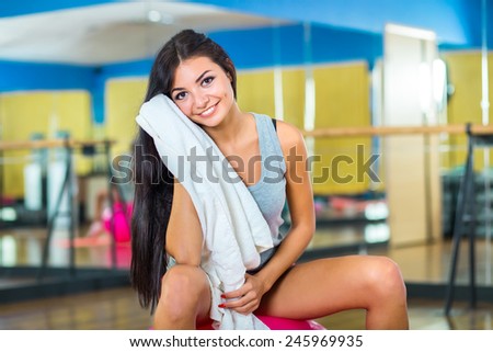 pretty slim girl relax with towel on ball after exercise