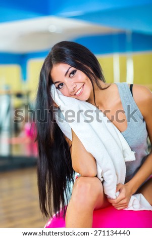 pretty slim girl relax with towel on ball after exercise