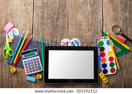 Tablet pc and different schoolchild and student studies accessories. Back to school concept.
