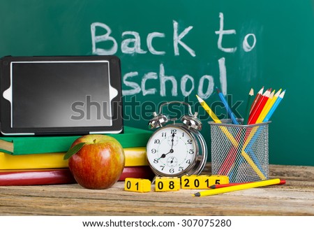 Tablet pc, Globe, notebook stack and pencils. Schoolchild and student studies accessories. Back to school concept.