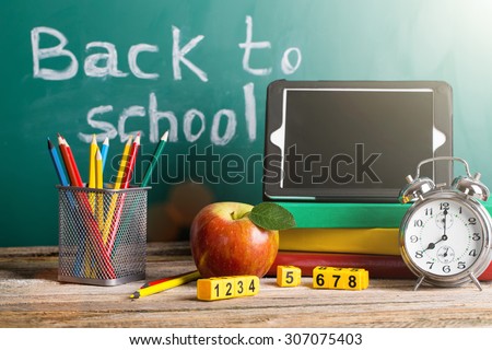 Tablet pc, Globe, notebook stack and pencils. Schoolchild and student studies accessories. Back to school concept.