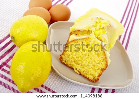 Homemade lemon cake , fresh lemon and brown eggs.