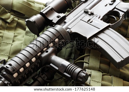 Military still life. AR-15 carbine (The Black Rifle) and tactical vest